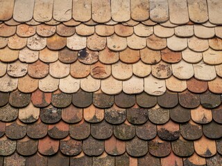 Old vintage style mossy weathered clay tile terracotta roof