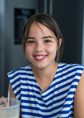 Close-up portrait of a cute smiling teenage girl