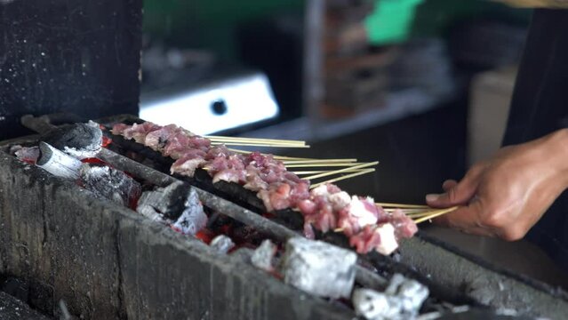 Grilling meat or lamb skewers. Indonesian traditional food. Tasty dish. Shot in 4k resolution.