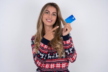 Photo portrait of Young beautiful woman doing purchase with pointing finger credit bank card