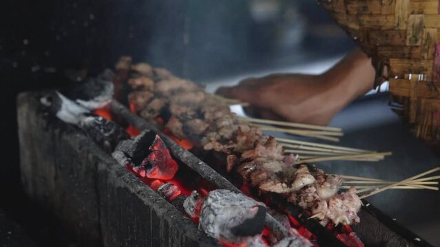 Grilling meat or lamb skewers. Indonesian traditional food. Tasty dish. Shot in 4k resolution. Slo-mo.