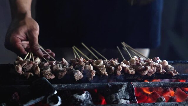 Grilling meat or lamb skewers. Indonesian traditional food. Tasty dish. Shot in 4k resolution. Slo-mo.