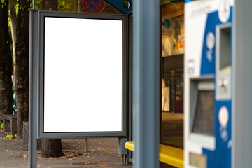 Billboard or display at a bus stop next to the ticket machine.