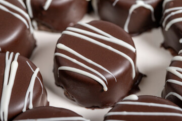 Chocolate cookie. Delicious cookies with coconut inside and chocolate outside on a wooden background. patisserie products. Close up