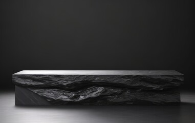 Black stone pedestal or platform on dark background. 