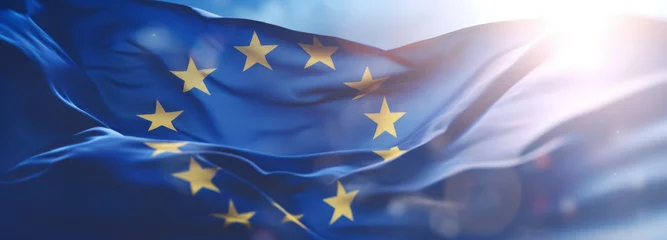 Schilderijen op glas Flag of European Union waving in the breeze against a sunset sky. Banner with EU flag. © MNStudio