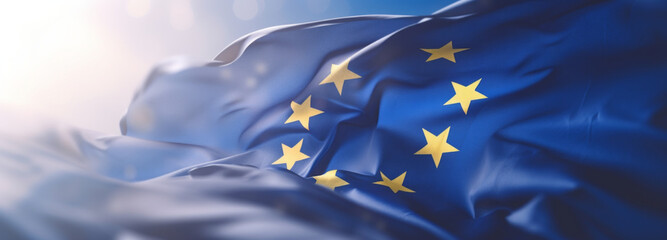 Flag of European Union waving in the breeze against a sunset sky. Banner with EU flag.