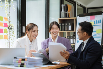 Businessmen team or financial data analysts working with tablets and laptop computers and data graphs together. Plan to analyzing projects in the office.