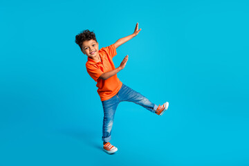 Full body size photo of dance cool little boy showing his arms dab carefree weekend positive mood disco isolated on blue color background