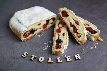 Sliced Chrismas stollen with powdered sugar and christmas decoration