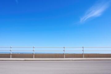 barrier or fence against a cloudless blue sky