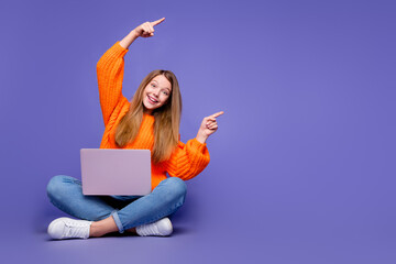 Full length photo of promoter girl direct forefingers empty space use laptop live broadcast twitch isolated on purple color background