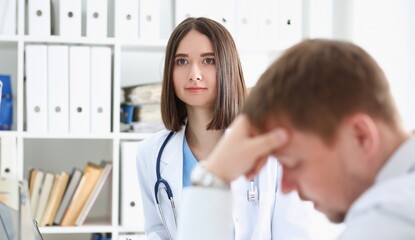 Friendly female doctor hold patient shoulder in office during reception. Examination result positive test calm down promise and cheer up grief and suffer treatment condolence ethics concept