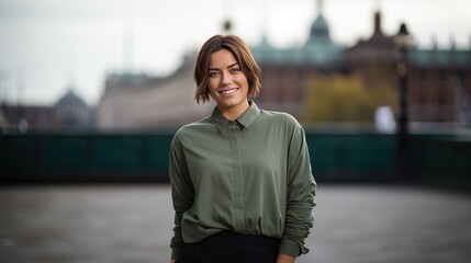 a beautiful woman with brown short hair standing against a London street.