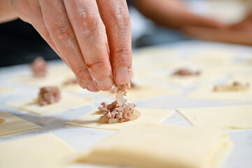 Female hands making Turkish food called manti    