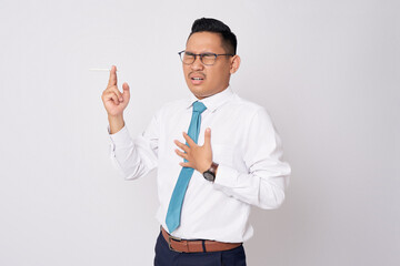 Unhealthy young Asian businessman got chest pain when smoking isolated on white background - obrazy, fototapety, plakaty