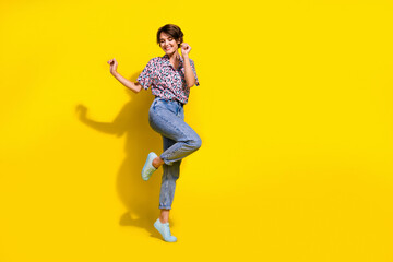 Fototapeta na wymiar Full body photo of excited cheerful lady dancing clubbing good mood empty space isolated on yellow color background
