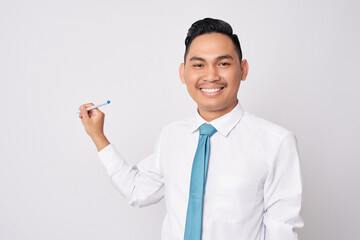 Excited young Asian businessman wearing a formal shirt and tie holding a pen while trying to write on copy space isolated on white background