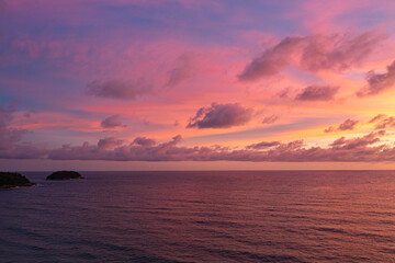 exotic pink red sky in sunset at Karon beach Phuket..Scene of colorful romantic sky sunset with changing the brilliant yellow sky gradually turned red. .beautiful sky of sunset in nature and travel 