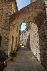 Walking narrow stone streets of small historic town Lucignano.