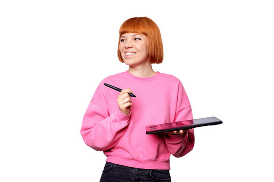 A smiling female designer in a pink sweet shot holding a graphic tablet.