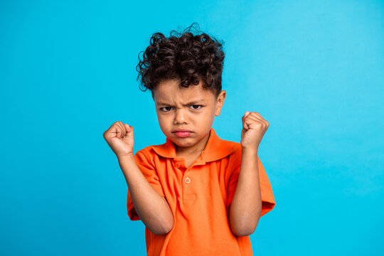 Photo of frustrated kid boy have fight with friends feeling outraged isolated blue color background