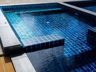 Floating bench seat, sitting zone in swimming pool with clean clear water, nobody. Square shaped...