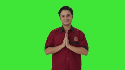 Happy Indian house keeper welcoming guests Green screen