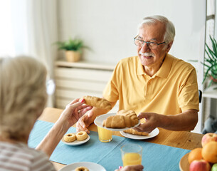 breakfast woman man senior couple home retirement wife husband elderly together happy morning old happiness kitchen love mature eating meal retired