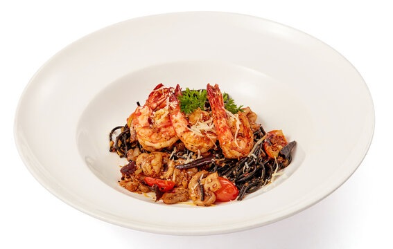 Black squid pasta stir fried with tiger shrimp and dried chilli (Thai Style) in white plate isolated on white background.