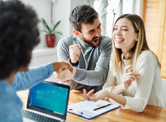couple woman man client agent handshake agreement young business home estate house deal meeting...