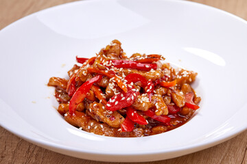crispy fried sesame chicken in white plate