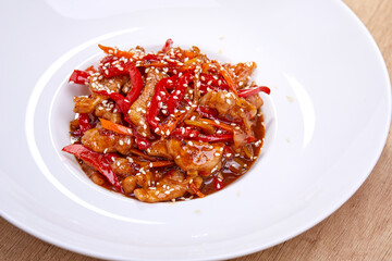 crispy fried sesame chicken in white plate