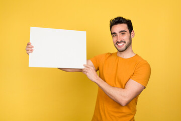 Smiling young man with blank panel in hand