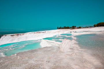 Pamukkale contains hot springs and travertines, terraces of carbonate minerals left by the flowing...