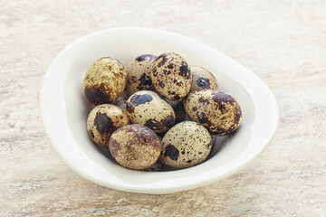 Raw quail eggs heap in the bowl