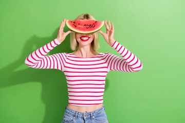 Photo of funny pleasant playful woman with bob hairstyle wear striped shirt hold watermelon on face...