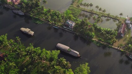 4k Aerial shot of houseboats travelling through backwaters in Alappuzha, Kerala, Drone shot