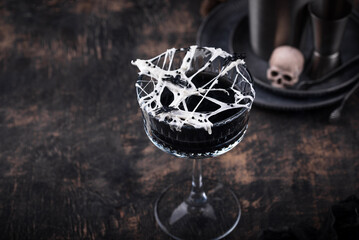 Fototapeta na wymiar Halloween cocktail with spider cobweb