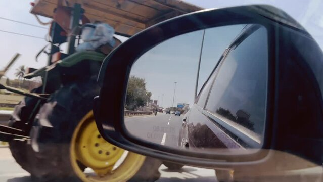 Side Concave mirror and a normal view of roadways from a moving car
