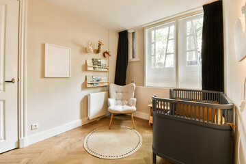 a baby's room with a cribt in the corner and a white rocking chair on the floor