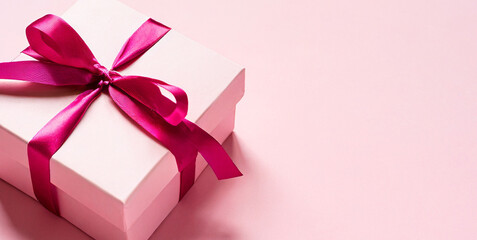 minimal pink pastel color gift box or present box with pink ribbon bow isolated on light pin 