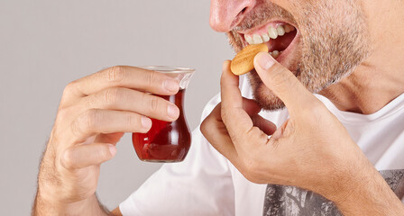 Man is eating fruits, close up mouth in the kitchen style.