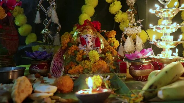 holy hindu god ganesha idol worship with holy offering and decoration at home at ganesh chaturthi