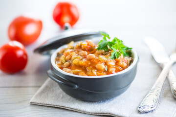 Cooked white beans with zucchini and other vegetables.