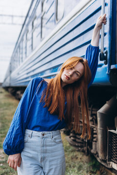 Red-haired woman outdoors at the train station
