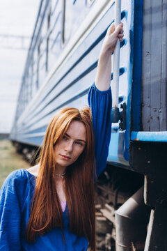 Red-haired woman outdoors at the train station