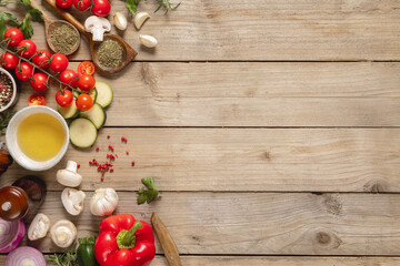 Top view healthy food cooking ingredients background with fresh vegetables, herbs, spices and olive...