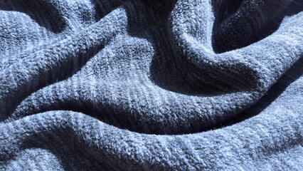 Gray-blue pile fleece fabric. Texture of warm fabric. Winter clothes. Fleece, polyester. Melange.