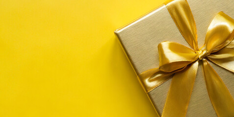 yellow golden gift box on yellow background golden gift box gift box with golden satin ribbo 